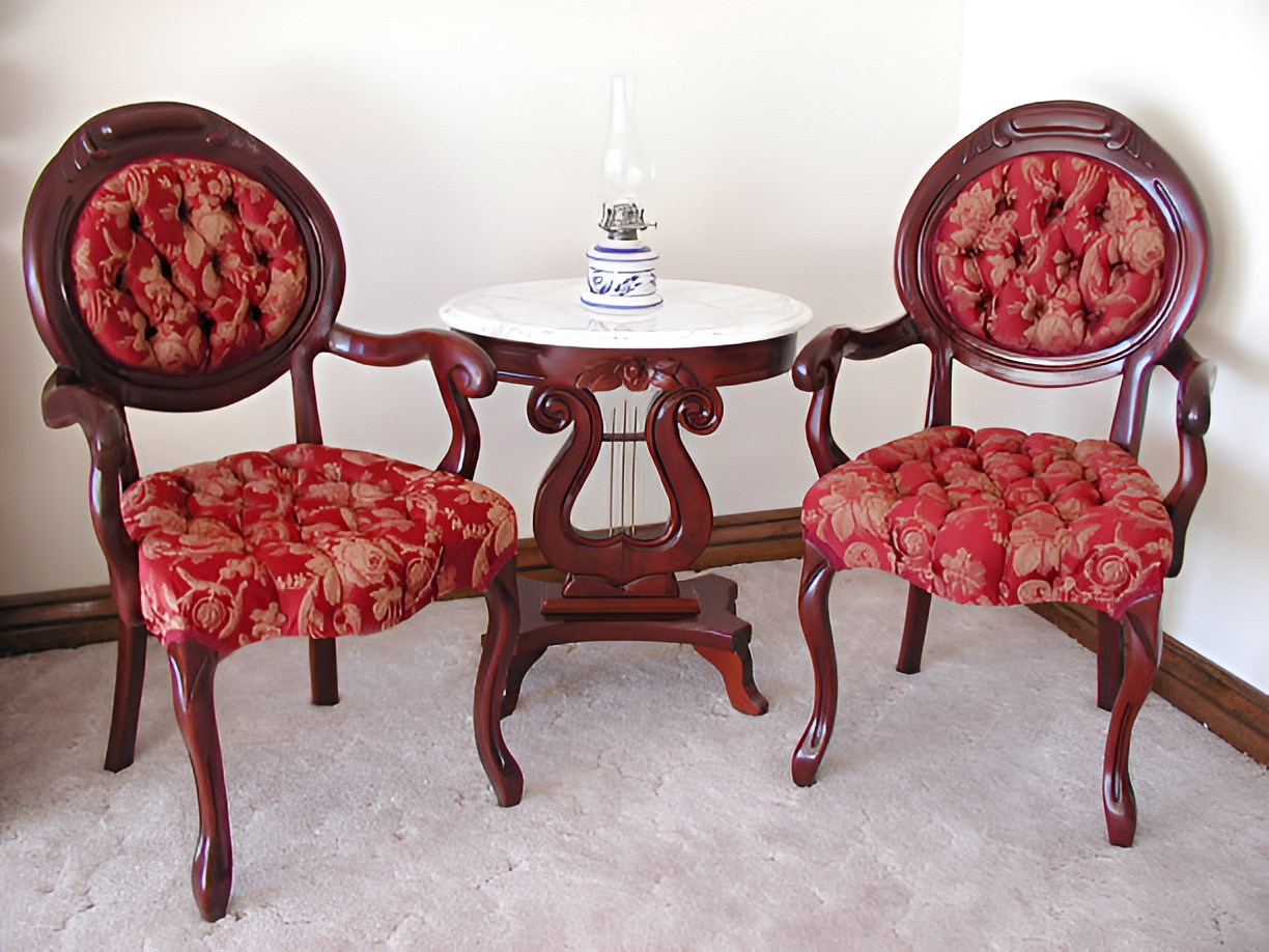 two antique chairs with red floral upholstery